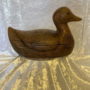 Porcelain duck figurine, wood grain look.